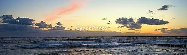 Sea coastline with waves. Baltic sea against dramatic cloudy sky at sunset. Panoramic nature landscape [IBR124497512]