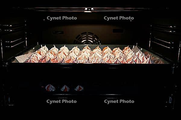 Process of making homemade meringue, Cooking sweet cream for dessert on baking sheet in oven [IBR124497514]