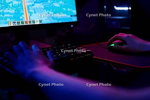 Professional gamer play computer video game in dark room, use neon colored rgb mechanical keyboard, place for cybersport gaming [IBR124497515]