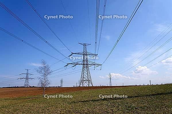Electricity pylons conducting current from distribution power station, blackout and grid stability concept, copy space [IBR124525358]