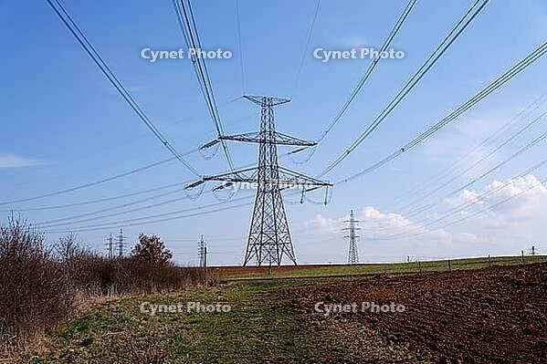 Electricity pylons conducting current from distribution power station, blackout and grid stability concept, copy space [IBR124525386]