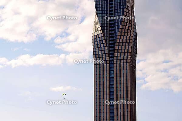 Paraglider with the tallest building in Scandinavia Karlatornet skycraper in Lindholmen, Gothenburg, Sweden, sunny day [IBR124525448]