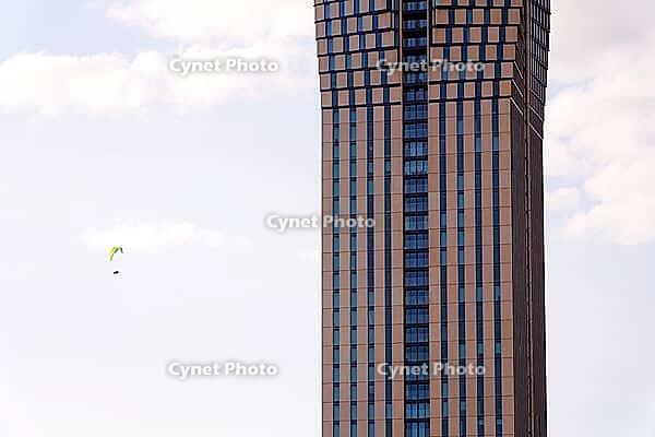 Paraglider with the tallest building in Scandinavia Karlatornet skycraper in Lindholmen, Gothenburg, Sweden, sunny day [IBR124525450]