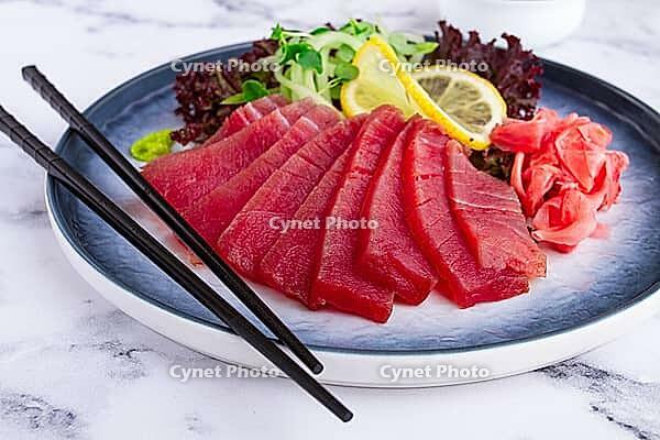 Tuna sashimi, with side dish, on a marble table, homemade, no people [IBR124552171]