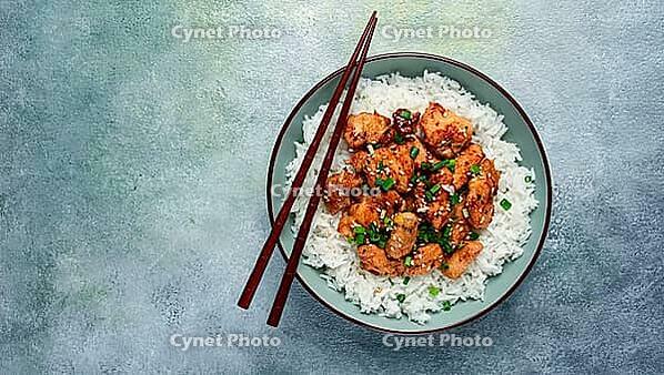 Fried chicken teriyaki with rice, green onion and sesame, homemade, no people [IBR124552191]