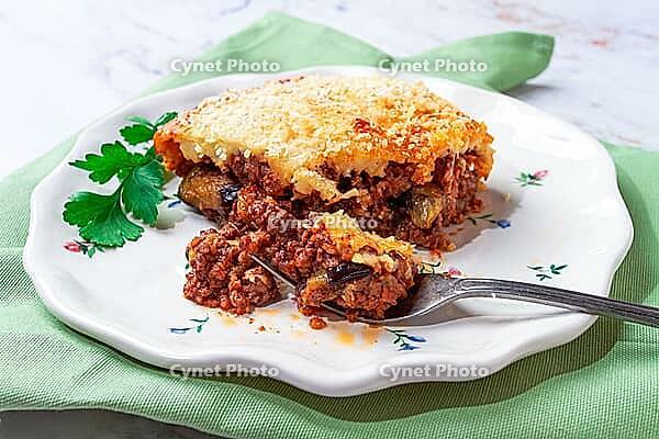 Sliced moussaka, Greek dish, baked eggplant with minced meat, with bechamel sauce, home cooking [IBR124552195]