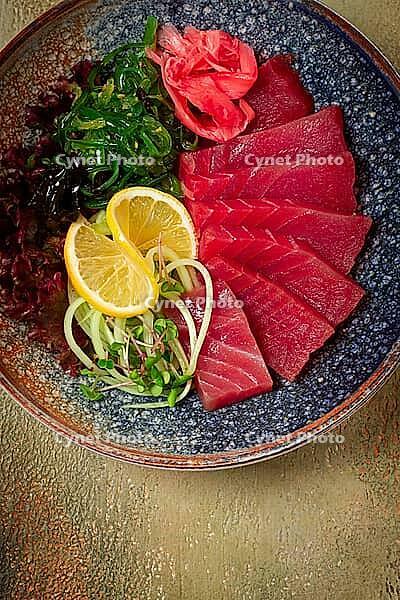 Tuna sashimi with daikon and wakame salad, pickled ginger, in a bowl [IBR124552198]