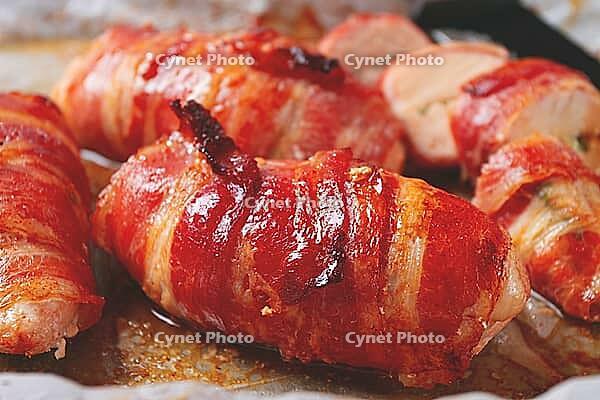 Baked chicken breast, wrapped in bacon, on a baking tray. in the home kitchen.close-up [IBR124552226]