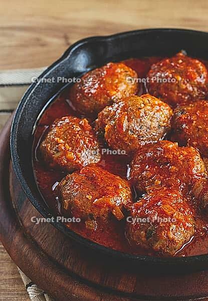 Minced meat meatballs, in tomato sauce, in a cast-iron pan, homemade, no people [IBR124552229]