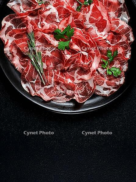 Sliced cured ham, prosciutto, italian dish, delicacy, parma ham, top view, no people [IBR124552242]