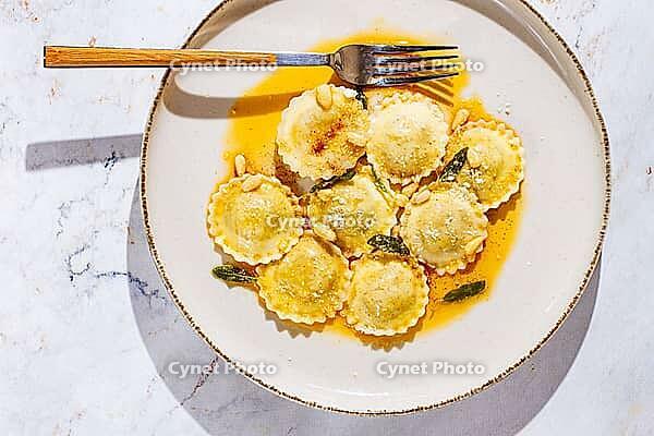 Italian dish, ravioli with butter and sage top view, no people [IBR124552252]