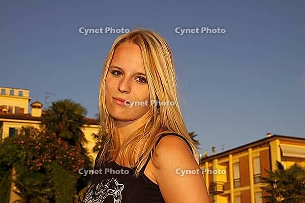 Pretty blonde girl in the old town of Lazise, Garda Lake, Italy - Nice blond girl in the old town of Lazise, Lake Garda, Italy [IBR124585321]