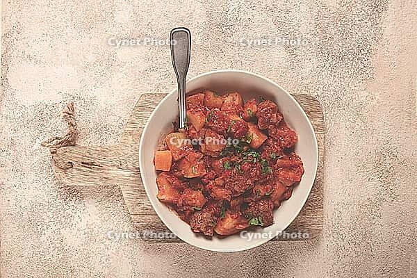 Stew with potatoes and vegetables, in tomato sauce, with spices and herbs, close-up, homemade, no people [IBR124585340]