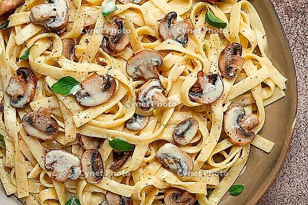 Fettuccine with champignons, basil, in cream sauce, homemade, no people [IBR124585351]