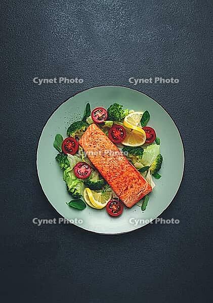 Grilled salmon fillet, with vegetables, broccoli, cherry, iceberg lettuce, spices and herbs, homemade, no people [IBR124585355]