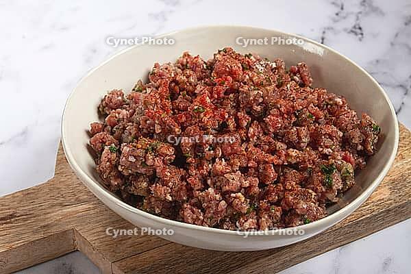 Raw minced meat, marinated with spices and herbs, in a bowl, minced meat with spices, top view, homemade, no people [IBR124585356]