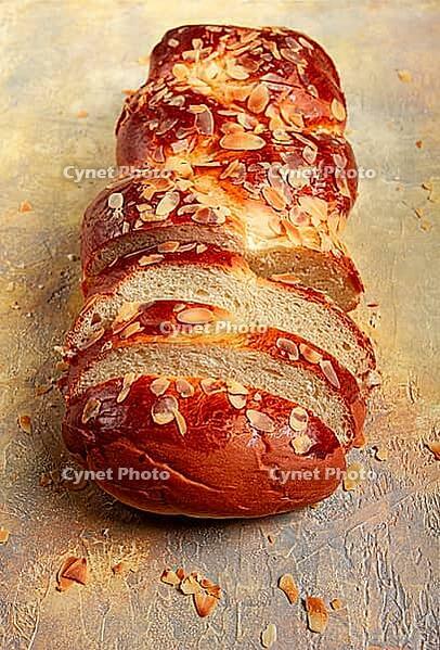 Braided, sweet bread pie, with sliced almonds, breakfast, braided bread, brioche, on a light background, top view, no people [IBR124585358]