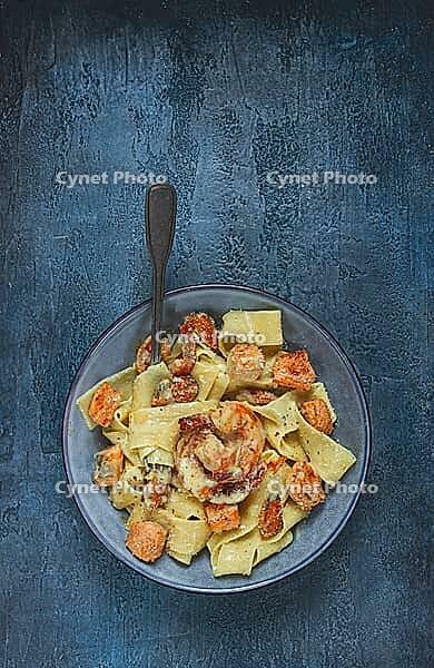 Papardelle pasta in creamy sauce with seafood, homemade, no people [IBR124585359]