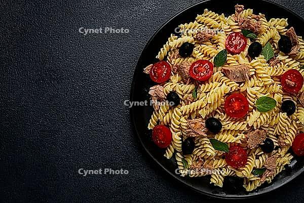 Tuna salad, fusilli pasta, olives and cherry, olive oil, homemade [IBR124585372]