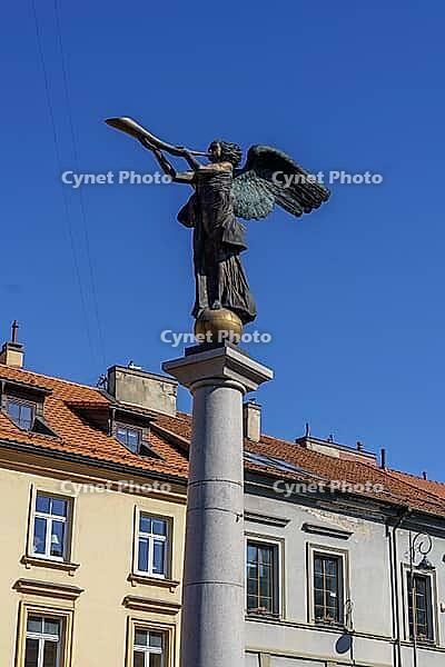 Angel statue with trumpet on a pillar against a blue sky, Vilnius, Lithuania, Baltic States [IBR124586568]