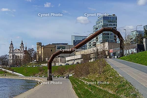 Modern and historic buildings along a river with large pipes along the waterfront, Vilnius, Lithuania, Baltic States [IBR124586573]