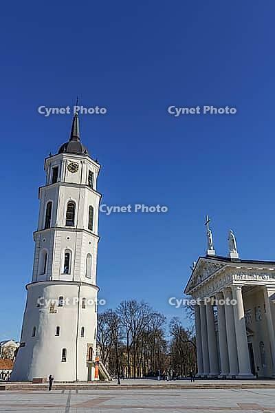 Church tower and classicist church under clear blue sky, Vilnius, Lithuania, Baltic States [IBR124586574]