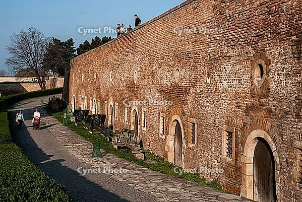 Belgrade, Serbia - March 29, 2014 - Historical brick fortress walls with people walking nearby on a sunny day [IBR124626844]