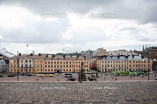Helsinki, Finland - August 28, 2014 - Busy city square with historic european architecture under cloudy skies [IBR124626903]