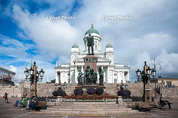 Helsinki, Finland - August 28, 2014 - Helsinki cathedral with cloudy sky and statue in the foreground [IBR124626904]