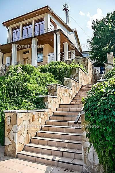 Kolomna, Russia - August 17, 2014 - Elegant modern house with stone staircase and lush greenery [IBR124626908]