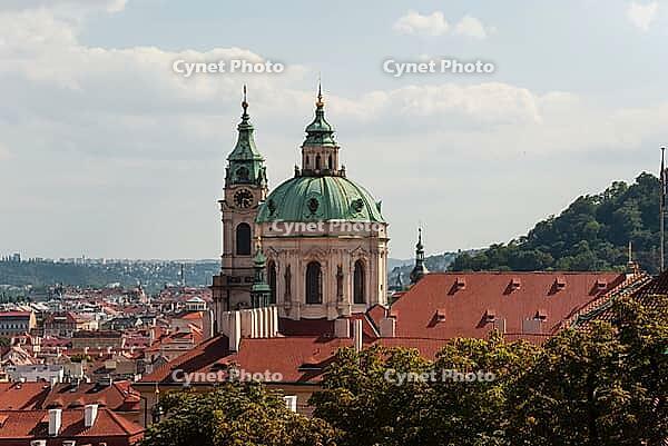 Prague, Czech - August 22, 2013 - St. nicholas church in prague: baroque architecture with red rooftops and cityscape view [IBR124626909]