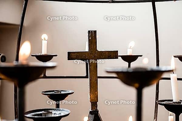 Serenity and reflection with candles and cross in peaceful setting [IBR124626915]