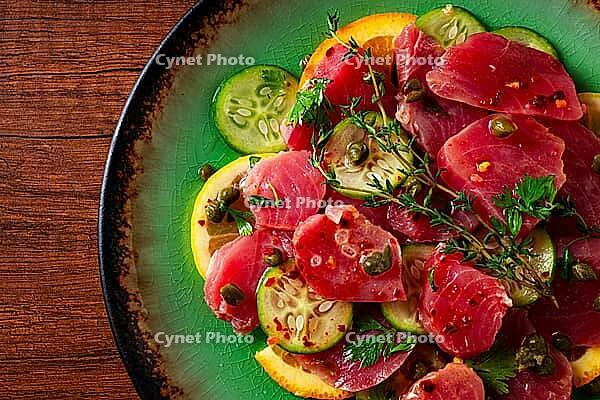 Sicilian tuna crudo, on a green plate, wooden table, Italian dish, homemade, no people [IBR124629124]