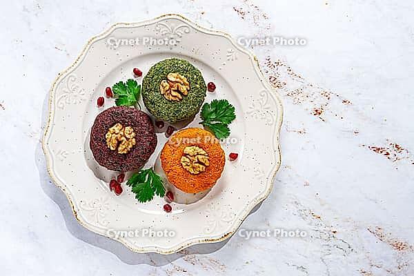 Assortment of Phali, three types, pumpkin, spinach and beetroot, on a round plate, Georgian dish, appetizer with nuts and spices, no people, homemade [IBR124629126]