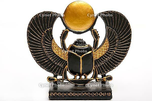 Egyptian scarab statue with outspread wings and a sun disk, detailed in gold and black [IBR124631248]