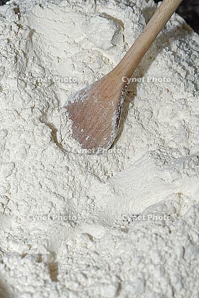 Wheat flour (Triticum aestivum) with wooden spoon, Krefeld, North Rhine-Westphalia, Germany [IBR124631260]