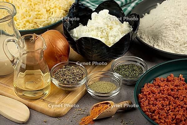 Recipe ingredients such as onions, spices, flour, bacon, and cheese [IBR124636277]