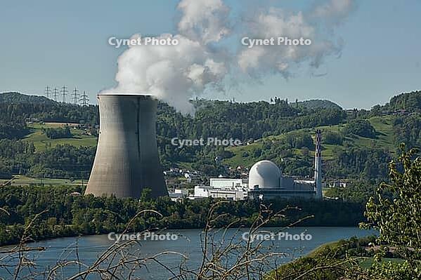 Nuclear power plant in Leibstadt with cooling tower and steam clouds, steam clouds over the nuclear power plant cooling turn, energy generation plant with nuclear power plant, nuclear power plant cooling tower between trees with steam clouds and power pol [IBR124636293]
