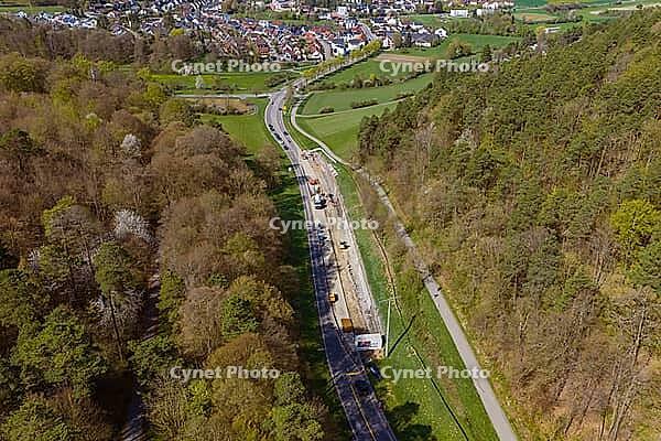 A road under construction runs through a rural, wooded area, construction of bicycle path, Aidlingen, Böblingen district, Germany [IBR124642853]