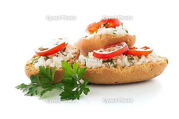 Closeup detail of bread with cottage and tomato over black ardoise tray [IBR124676049]