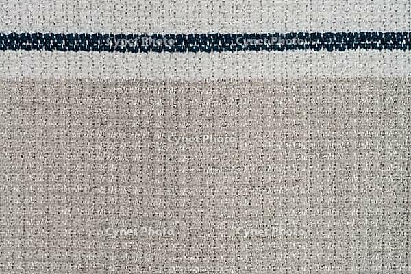 Closeup detail of beige fabric texture background [IBR124676094]