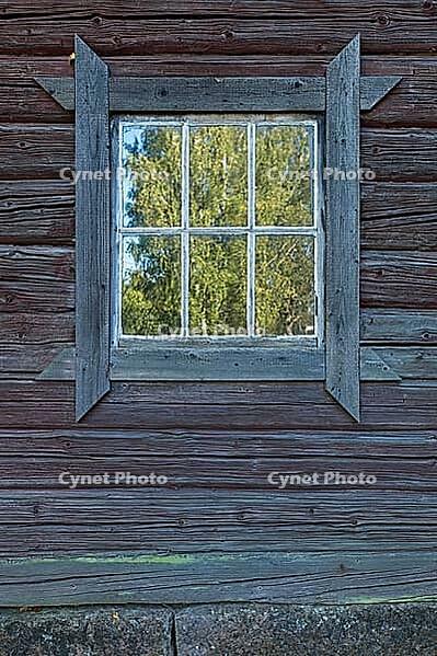 Old wooden window with a rustic frame on a log building, Ruostinpyhtää, Finland [IBR124748940]