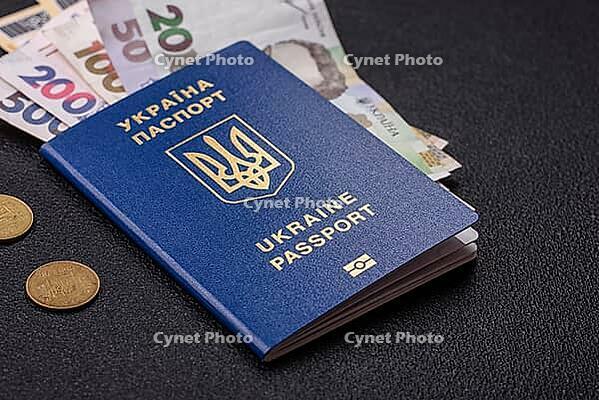 Food, Biometric Ukrainian passport, flight tickets and money on a dark concrete background. Conceptual background on the theme of tourism and travel [IBR124773706]