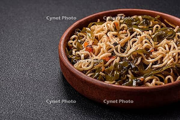 Food, Asian dish rice noodles with salt and spices on dark concrete background [IBR124773750]