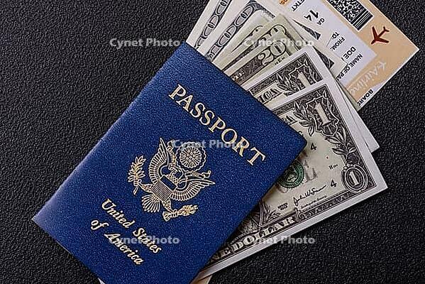 Food, United states of america passport, airline tickets and money on a dark concrete background. Conceptual background on the theme of tourism and travel [IBR124773752]