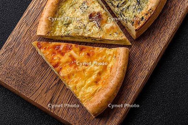 Food, Delicious quiche with broccoli, chicken or salmon and cheese with salt and spices on a dark concrete background [IBR124773758]