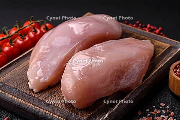 Food, Fresh chicken fillet on a dark concrete table with spices and herbs. Preparation for cooking meat dishes [IBR124773775]