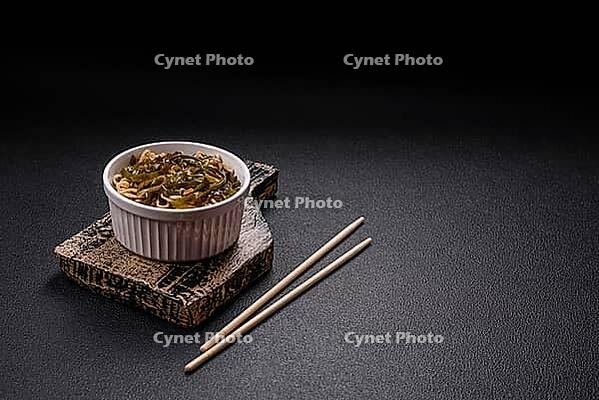 Food, Asian dish rice noodles with salt and spices on dark concrete background [IBR124773779]