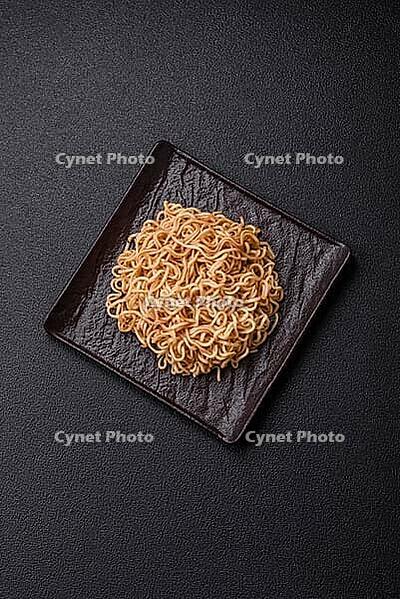 Food, Asian dish rice noodles with salt and spices on dark concrete background [IBR124773781]