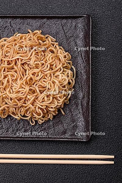 Food, Asian dish rice noodles with salt and spices on dark concrete background [IBR124773782]